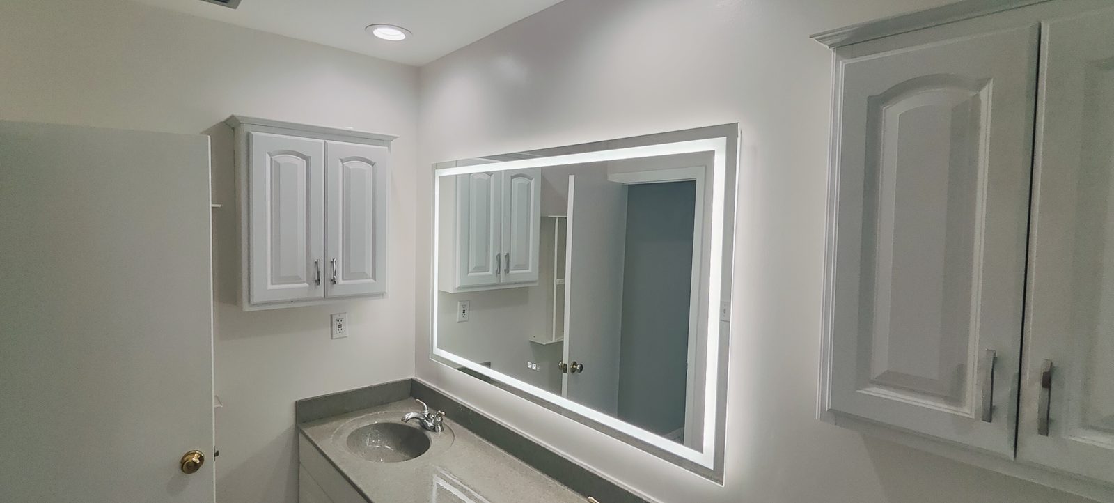 Bathroom cabinets and illuminated mirror